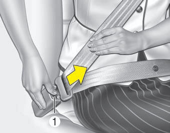 The seat belt is released by pressing the release button (1) on the locking buckle.